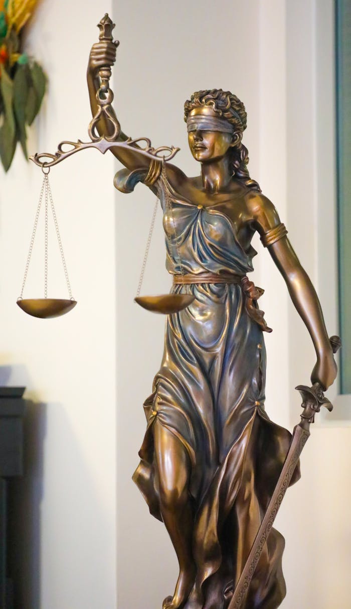 The Art of Drawing Readers In: Your attractive post title goes here Bronze Lady Justice statue with scales and sword, symbolizing law and fairness, displayed indoors in İstanbul.